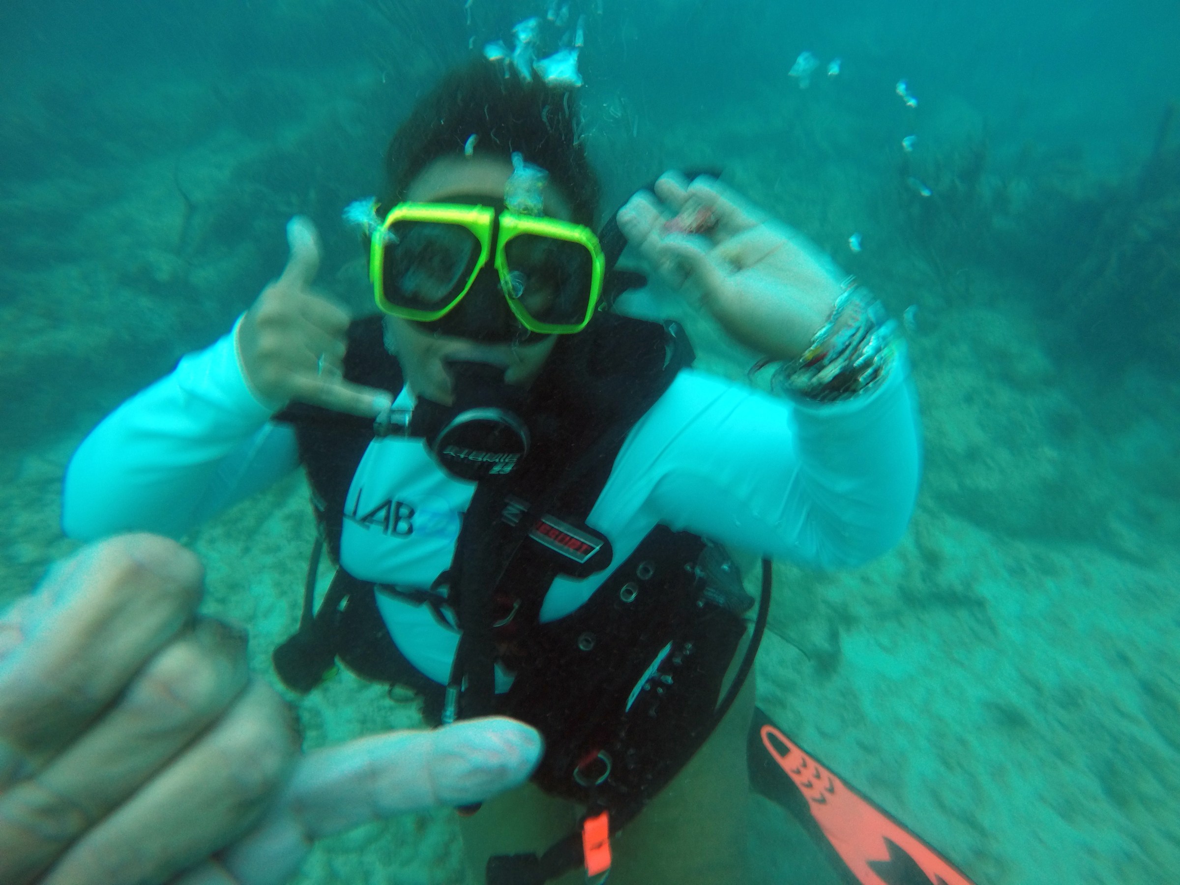 Woman signaling chaka while scuba diving