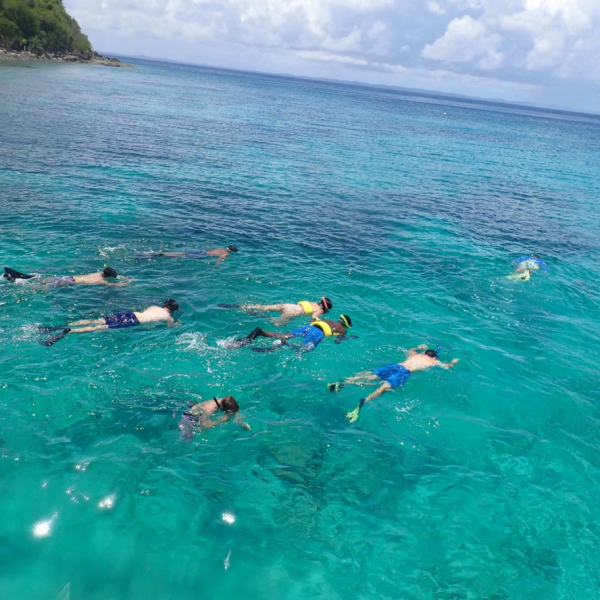 a group of people swimming in a body of water