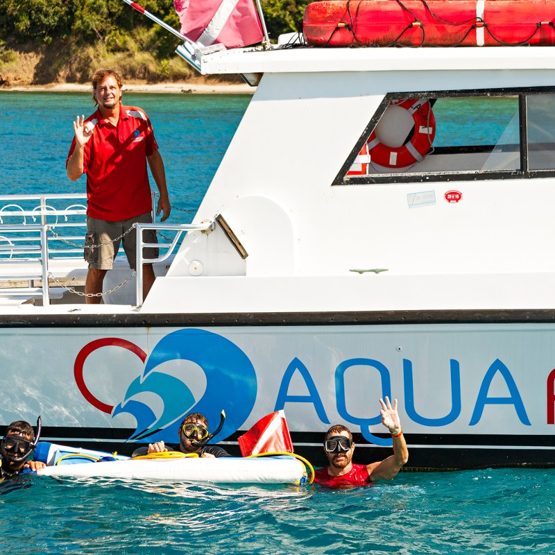 Aqua Adventure boat with crew waving hi