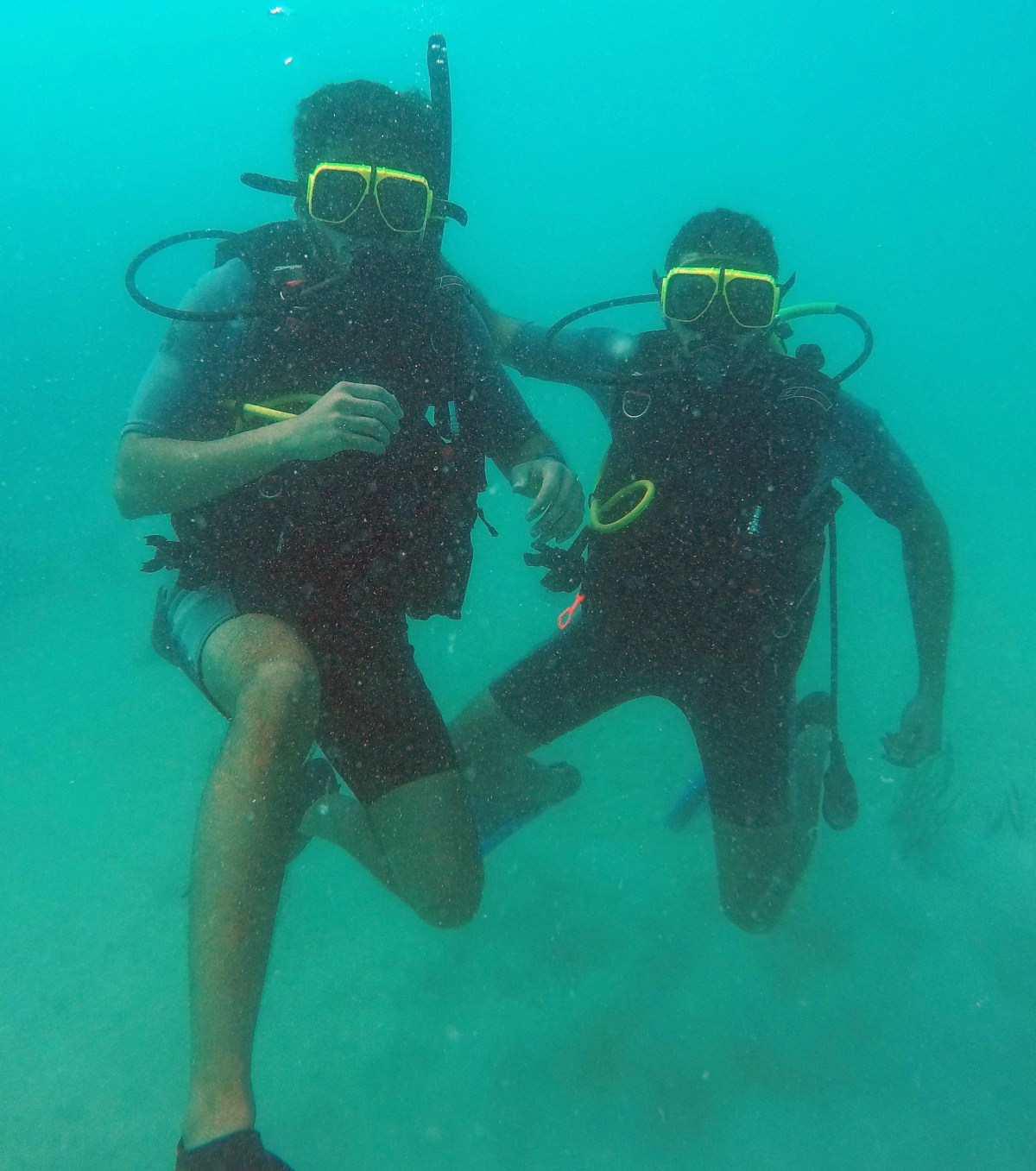 Two scuba divers drifting in ocean