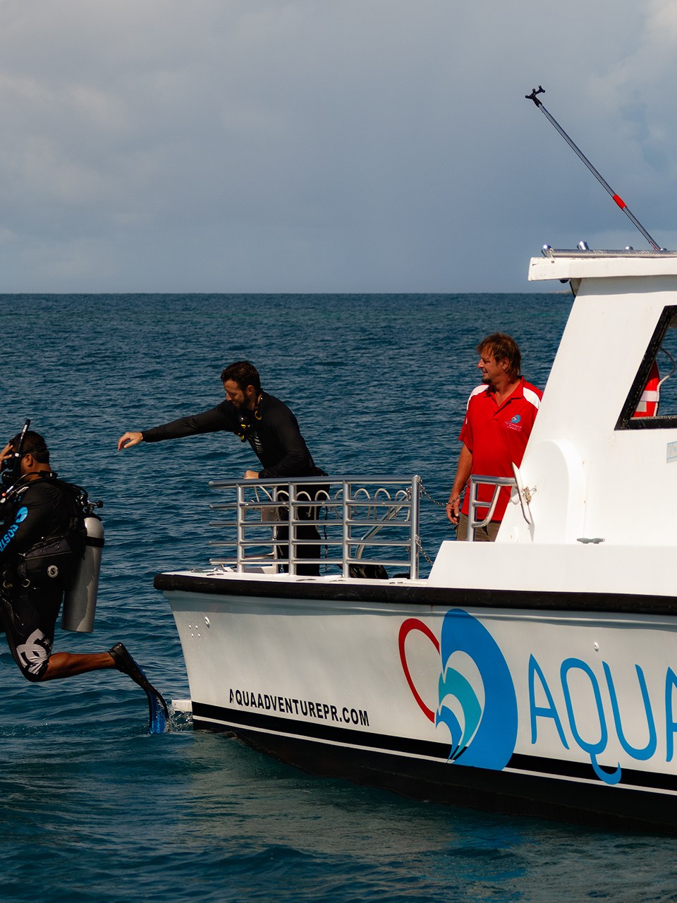 Boat Diver jumping into water from boat