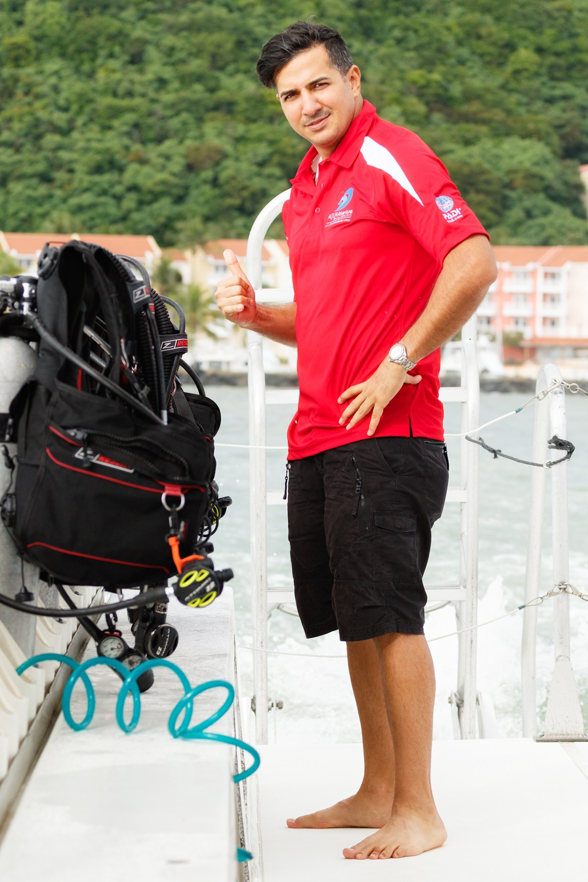Scuba instructor showing scuba diving equipment